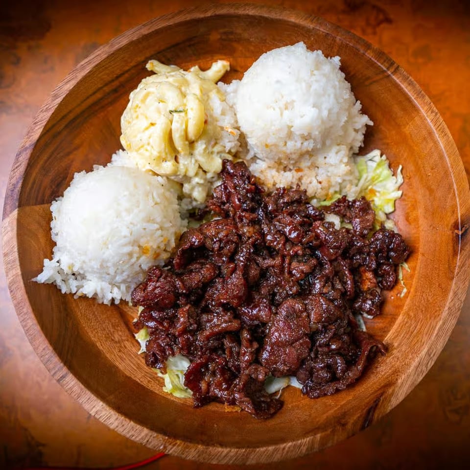 Hawaiian plate lunch with kalbi short ribs, two scoops of rice, and macaroni salad in a wooden bowl.